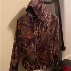 Camo Storm1, Waterproof, Cold Gear Hoodie. Youth Large, Never Worn. Youth Large Brown Long Sleeve Hoodie For Outdoor Activities, Camouflage Hoodie Outerwear For Outdoor Activities, Camouflage Hoodie Outerwear For Outdoor, Under Armour Long Sleeve Windbreaker For Outdoor Activities, Long Sleeve Hooded Jacket For Fall Camping, Hooded Under Armour Outerwear For Outdoor Activities, Fall Camping Hooded Jacket With Long Sleeves, Under Armour Hooded Outerwear For Outdoor Activities, Camouflage Long Sleeve Hoodie For Outdoor Activities