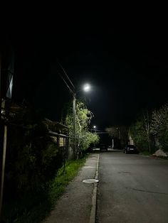 an empty street at night with the light on