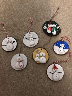 christmas ornaments with snowmen on them are sitting on the floor next to each other