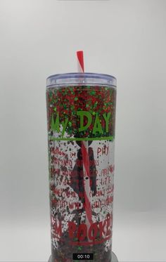 the tumbler cup is decorated with red and green confetti