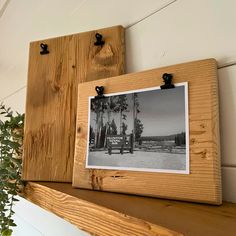 an old photo hanging on a wooden shelf