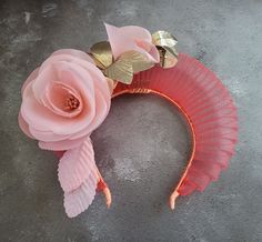 "Presenting a beautiful coral orange halo style  headpiece with peachy pink colour silk flower and gold leather leaf detail on a satin ribbon covered headband with hair comb slide. This stunning headpiece is adorned with a silk rose flower vine which extends above the headband and is wired so the flowers can be adjusted slightly to work with your hair style. Its also delightfully lightweight to wear. Shown above on one of our stunning clients who kindly shared up pictures. Perfect to add a uniqu Headband Fascinator, Halo Fascinator, Coral Headpiece, Elegant Orange Summer Headpiece, Orange Headband Fascinator For Wedding, Flower-shaped Fascinator With Matching Headband For Party, Orange Fascinators, Luxury Flower-shaped Fascinator For Wedding, Luxury Flower-shaped Wedding Fascinator