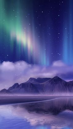 the sky is filled with bright green and purple aurora bores above mountains, reflecting in water