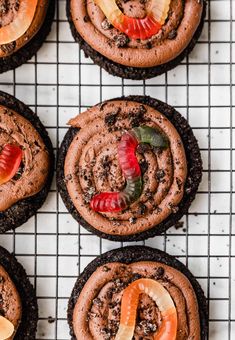 cookies with chocolate frosting and fruit toppings on a cooling rack for display or to eat