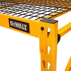 a close up of a yellow metal table with the words dewt on it