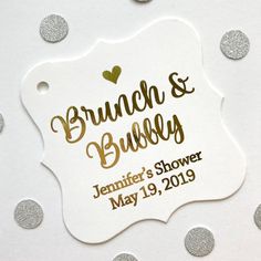 a white and gold brunch and bubbly tag with silver confetti on it