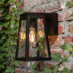 two lights are attached to a brick wall