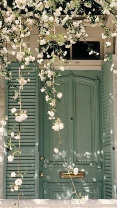 a green door with white flowers on it