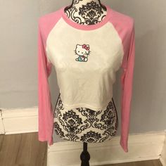 This Is A Pink And White Hello Kitty Long Sleeve Crop Top. It’s Ribbed And A Bit See Through. Also Has Some Wrinkles Due To Being In Storage, But Still In Good Condition Because It’s Brand New. Great For Any Hello Kitty Fan Playful Hello Kitty Tops For Spring, Spring Hello Kitty Playful Tops, Fitted Hello Kitty Top For Spring, Fitted Hello Kitty Tops For Spring, Hello Kitty Long Sleeve Cotton Top, Fitted Cotton Hello Kitty Top, Fitted Hello Kitty Crew Neck Top, Spring Fitted Hello Kitty Tops, Long Sleeve Cotton Hello Kitty Top