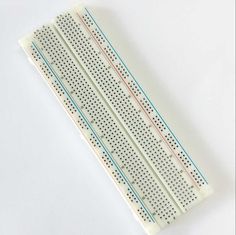 an electronic device with four rows of dots on it