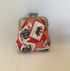 a red and white purse with playing cards on it