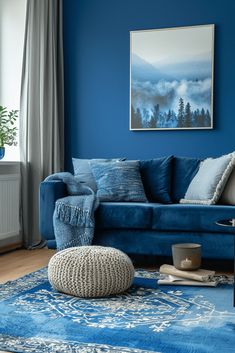 a living room with blue walls and rugs on the floor in front of it