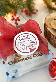 some cookies are sitting on a table next to a red bow and candy canes