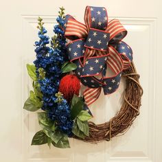 a patriotic wreath with red, white and blue flowers