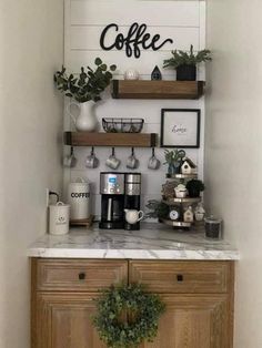 a coffee bar with two shelves above it and some plants on the counter top in front of