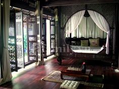 an ornate bedroom with wooden floors and white drapes