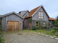 the house is made of wood and has two garages