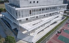 an aerial view of a tennis court with stairs leading up to the upper floor and second story