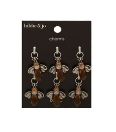 three bee charms with crystals on them