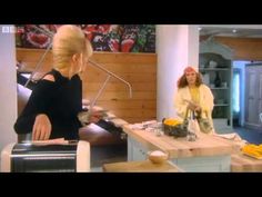 two women in a kitchen preparing food on the stove top and one woman standing at the counter