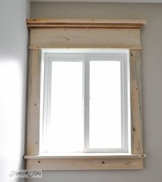 a white window with wooden frame in a room