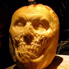 a carved pumpkin with an evil face on it