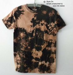 a brown and black tie dye shirt hanging on a wall