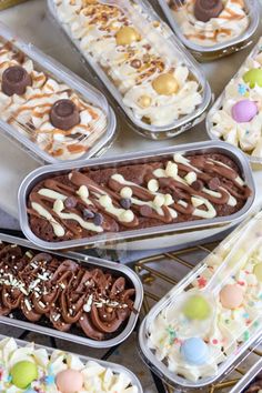 many different desserts in plastic containers on a table