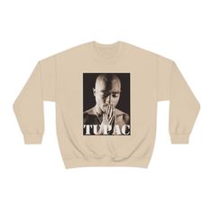 Tupac Shakur Pullover Sweater Ideal for any situation, a unisex heavy blend crewneck sweatshirt is pure comfort. These garments are made from polyester and cotton. This combination helps designs come out looking fresh and beautiful. The collar is ribbed knit, so it retains its shape even after washing. There are no itchy side seams on these sweaters. .: 50% cotton, 50% polyester .: Medium-heavy fabric (8.0 oz/yd² (271.25 g/m .: Loose fit .: Sewn-in label .: Runs true to size Urban Style T-shirt With Ribbed Cuffs For Fall, Heavyweight Urban Sweatshirt For Fall, Urban Heavyweight Sweatshirt For Fall, Heavyweight Letter Print Sweatshirt For Fall, Heavyweight Crew Neck Sweatshirt For Fall, Heavyweight Sweatshirt For Fall Streetwear, Heavyweight Graphic Print Sweatshirt For Fall, Fleece Crew Neck Sweater For Streetwear, Crew Neck Fleece Sweater For Streetwear