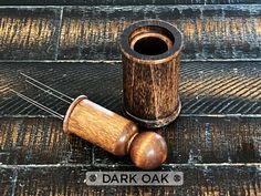 a wooden cup sitting on top of a floor next to a pair of mallets