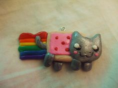 a small toy cat with a rainbow on it's back