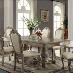 a dining room table with chairs around it