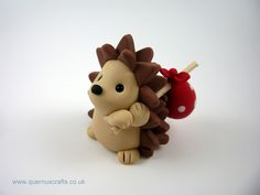 a toy hedgehog with a red apple on it's back and its tail curled up