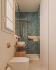 a bathroom with a toilet, sink and shower