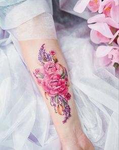 a woman's arm with pink flowers on it