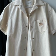 ** Miu Miu Denim Short-Sleeved Shirt ** Beige Denim Shirt From Miu Miu Classic Short-Sleeved Shirt Featuring Embroidery On The Chest Retail Price : $1,150 Worn Once For Sizing - Basically Brand New Size 40, Tts L Should You Have Any Questions, Please Feel Free To Dm Me! Miu Miu Denim, Mui Mui, Denim Short, Denim Shirt, Casual Shirts For Men, Shirt Color, Dm Me, Miu Miu, Casual Button Down Shirts