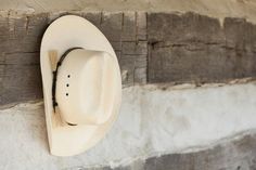 a white cowboy hat mounted to the side of a wall