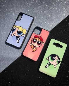 the powerpuff girls phone cases are next to each other on a black surface