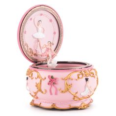 a pink and gold box with a ballerina figure in the center, on a white background