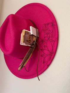 Be the life of the rodeo in this gorgeous boho red hat featuring a bull, poppies, and playful longhorns. Add this accessory to your wardrobe for a unique western touch. Trendy Hats For Kentucky Derby Festival, Vintage Fedora For Spring Rodeo, Adjustable Western Felt Hat For Spring, Spring Western Felt Hat With Adjustable Fit, Trendy Adjustable Felt Hat For Rodeo, Adjustable Pink Fedora For Fall, Trendy Fedora For Spring Rodeo, Red Western Hat For Fall, Bohemian Red Hats For Kentucky Derby