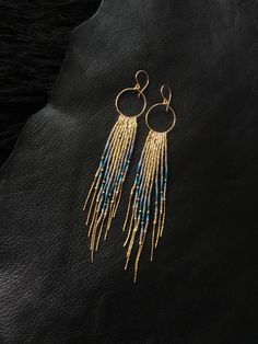 "Maui Swan Designs beautiful, glamorous long Glass Beadwork and handmade 14K gold filled Hoop Earrings with 14K gold filled chain fringe. Indigenous inspired glass seed bead earrings. Original design using tiny Czech glass seed beads hand sewn beautifully together with 14K gold filled chain and handmade Hoop, silver lined glass seed beads, 14K gold filled twisted buggle beads & nylon thread coated in Maui beeswax to maintain strength. 5\" long delicate earrings incorporating tones of gold , Bohemian Beaded 14k Gold Filled Earrings, Bohemian 14k Gold Filled Beaded Dangle Earrings, Bohemian 14k Gold-filled Beaded Dangle Earrings, Bohemian 14k Gold Filled Beaded Earrings, Bohemian 14k Gold-filled Beaded Earrings, Bohemian 14k Gold Filled Round Beaded Earrings, Dangle Beaded Earrings With 14k Gold Filled, 14k Gold-filled Dangle Beaded Earrings With Gold Beads, 14k Gold Filled Dangle Beaded Earrings With Gold Beads