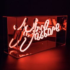 an illuminated display case with scissors and hairdryer in the middle, on a black background