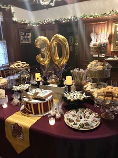 a table topped with lots of food next to a number 30 balloon in the air