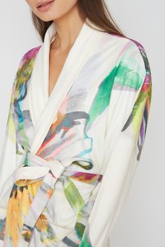 Indulge in the soft, absorbent, and breathable fabric of this Aquarelle Short Robe. With a chic and classy design, it is machine washable and will bring out your inner artist. You will love the comfortable and stylish feel of this robe. One size Short bath/lounge Robe Shawl collar 2 bottom side pockets Sewn in belt Made of soft and absorbent microfiber Machine wash cool Tumble-dry low Multicolor Silk Robe For Spring, Chic Summer Sleep Robe, White Silk Sleepwear For Spring, Summer Silk Loungewear Robe, Summer Silk Lounge Robe, White V-neck Robe For Spring, Fitted Kimono For Spring Loungewear, Cream Summer Robe For Loungewear, Silk Sleepwear For Spring Lounging