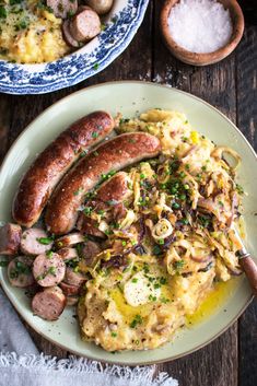 two plates with sausages and pasta on them