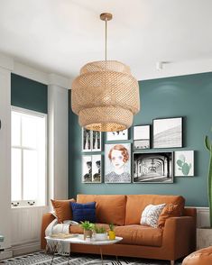 a living room filled with furniture and pictures hanging on the wall above it's coffee table