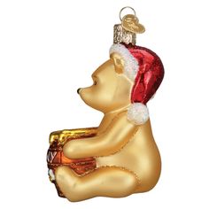 a glass ornament with a bear wearing a santa hat and holding a bell