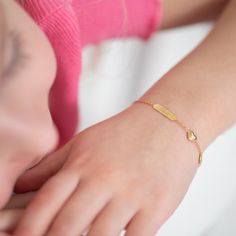 This 14k gold bracelet is a precious keepsake for any little girl. The small puffed heart charm adds a touch of elegance and sentimentality to this already stunning piece. Measuring at 5 inches, it is perfect for little wrists, and can be extended up to 6 inches to accommodate growth. The bracelet can also be engraved with a personalized message, making it a one of a kind gift for a special occasion or just because. This bracelet is sure to become a treasured piece for years to come, serving as a reminder of love and affection. Gift Box included with purchase. Age Group: Sweet Gifts For Babies, Toddlers & Little Girls; Safe for Sensitive Skin Material: 14k Yellow Gold Bracelet Length: 5 inches with 1" Extension; Tag: 14mm W x 4mm H Charm Size: 7mm W x 7mm H Heart Metal Stamp: 14k Gift Box Personalized Hypoallergenic Yellow Gold Name Bracelet, Delicate Personalized Heart Bracelet As A Gift, Personalized Dainty Yellow Gold Bracelet, Dainty Personalized Yellow Gold Bracelet, Gold Sterling Silver Charm Bracelet For Birthday, Gold Heart Bracelets With Name, Dainty Gold Name Bracelet With Heart Charm, Classic Heart Charm Bracelet As Gift, Dainty 14k Gold Personalized Charm Bracelet