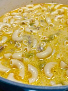 a blue pot filled with pasta and broth