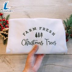 someone is holding up a christmas tree embroidered onto a white bag with the words farm fresh on it